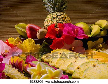 Stock Photograph - Studio Shot Of A Variety Of Tropical Fruit, Whole And Cut Into Slices.. Fotosearch
