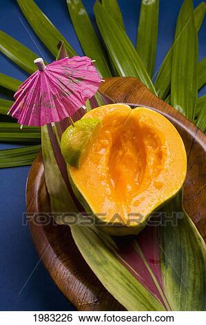 Studio Shot Of Half Of A Papaya, Seeds Removed, With Cocktail Umbrella. View Large Photo Image Stock Photograph - Studio Shot Of Half Of A Papaya, Seeds Removed, With Cocktail Umbrella.. Fotosearch