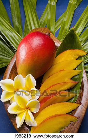 Studio Shot Of Mango, Whole And Cut Into Slices, With Flowers. View Large Photo Image Stock Photo - Studio Shot Of Mango, Whole And Cut Into Slices, With Flowers.. Fotosearch