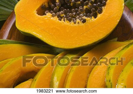 Stock Image - Studio Shot Of Papaya, Halved And Cut Into Slices.. Fotosearch