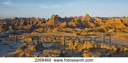 The eroded formations of badlands national park light up at sunrise from the window and door trail; south dakota united states of america View Large Photo Image Stock Photography - The eroded formations of badlands national park light up at sunrise from the window and door trail; south dakota united states of america. Fotosearch