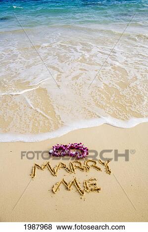 Stock Photo - Turquoise Ocean, Foaming Shore Water, Orchid Lei, Marry Me Written In Sand. Fotosearch