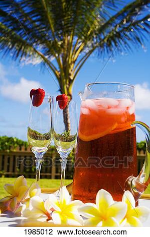 Two Glasses Next To A Pitcher Filled With A Tropical Drink. View Large Photo Image Stock Image - Two Glasses Next To A Pitcher Filled With A Tropical Drink.. Fotosearch