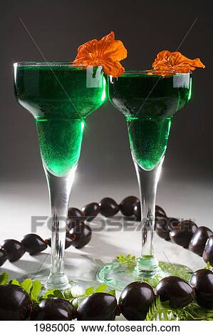 Two Tropical Cocktails Garnished With Flowers And Kukui Nuts. View Large Photo Image Stock Photography - Two Tropical Cocktails Garnished With Flowers And Kukui Nuts.. Fotosearch