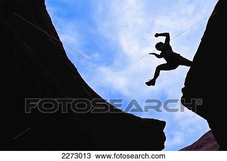 Woman jumping across a canyon gap; san rafael swell utah united states of america View Large Photo Image Stock Image - Woman jumping across a canyon gap; san rafael swell utah united states of america. Fotosearch