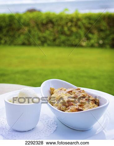 Stock Photo - A food item served in a white serving dish with a view of of the ocean; Hawaii united states of america. Fotosearch