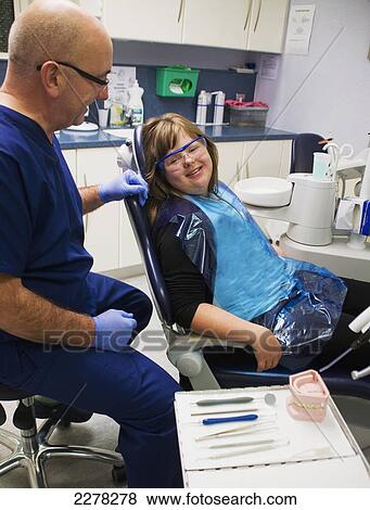 A girl and her dentist during a dental exam; Whitley bay tyne and wear england View Large Photo Image Stock Photo - A girl and her dentist during a dental exam; Whitley bay tyne and wear england. Fotosearch