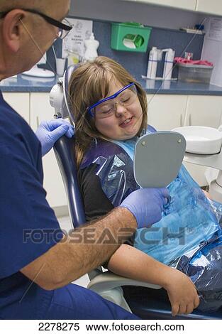 A girl and her dentist during a dental exam; Whitley bay tyne and wear england View Large Photo Image Stock Photography - A girl and her dentist during a dental exam; Whitley bay tyne and wear england. Fotosearch