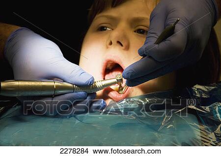 Picture - A girl undergoing treatment at the dentist's office; Whitley bay tyne and wear england. Fotosearch