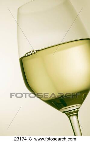 A glass of white wine View Large Photo Image Stock Photo - A glass of white wine. Fotosearch