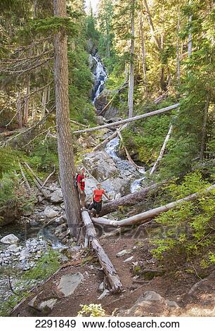 Stock Photo - A mature couple at a waterfall on a hike in to rainbow lake; Whistler british columbia canada. Fotosearch