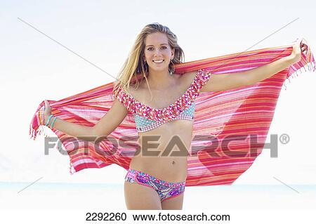 A teenage girl in a bikini holding a wrap with the ocean in the background; Maui hawaii united states of america View Large Photo Image Stock Image - A teenage girl in a bikini holding a wrap with the ocean in the background; Maui hawaii united states of america. Fotosearch