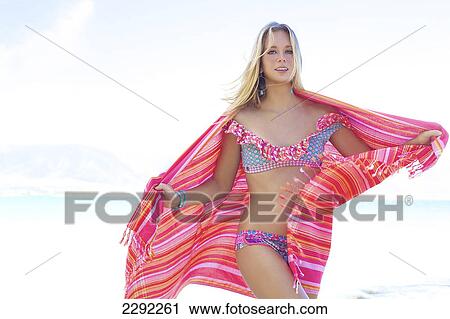 A teenage girl in a bikini holding a wrap with the ocean in the background; Maui hawaii united states of america View Large Photo Image Stock Image - A teenage girl in a bikini holding a wrap with the ocean in the background; Maui hawaii united states of america. Fotosearch