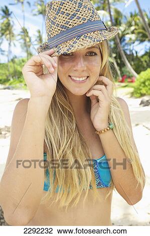 A teenage girl on the beach in a two piece bathing suit and hat; Maui hawaii united states of america View Large Photo Image Stock Image - A teenage girl on the beach in a two piece bathing suit and hat; Maui hawaii united states of america. Fotosearch