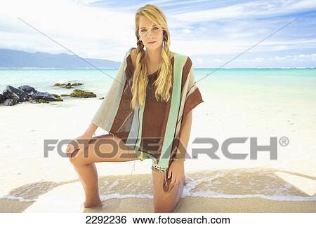 A teenage girl posing on the beach wearing a swimsuit cover-up; Maui hawaii united states of america View Large Photo Image Stock Photograph - A teenage girl posing on the beach wearing a swimsuit cover-up; Maui hawaii united states of america. Fotosearch