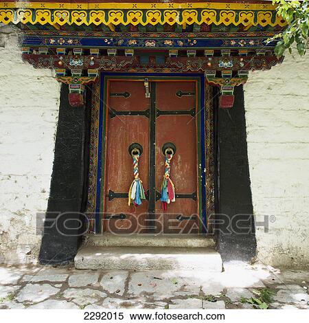 Colourful fabric tassels tied to the doorknobs on the doorway of a building; Lhasa xizang china View Large Photo Image Stock Photography - Colourful fabric tassels tied to the doorknobs on the doorway of a building; Lhasa xizang china. Fotosearch