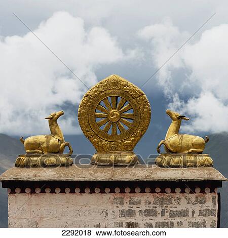 Gold religious symbols on top of a wall ledge with clouds in the background; Lhasa xizang china View Large Photo Image Stock Photo - Gold religious symbols on top of a wall ledge with clouds in the background; Lhasa xizang china. Fotosearch