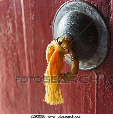 Gold tassel tied to a doorknob on a red door; Lhasa xizang china View Large Photo Image Stock Photograph - Gold tassel tied to a doorknob on a red door; Lhasa xizang china. Fotosearch