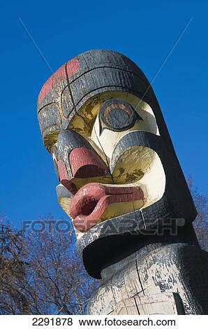Head of a totem pole against a blue sky; Edmonton alberta canada View Large Photo Image Stock Photo - Head of a totem pole against a blue sky; Edmonton alberta canada. Fotosearch