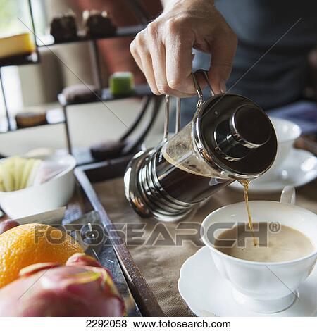 Man pouring coffee into a cup from a coffee press; Lhasa xizang china View Large Photo Image Stock Photo - Man pouring coffee into a cup from a coffee press; Lhasa xizang china. Fotosearch