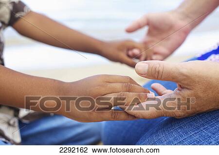 Mother and son holding hands; Hawaii united states of america View Large Photo Image Stock Image - Mother and son holding hands; Hawaii united states of america. Fotosearch