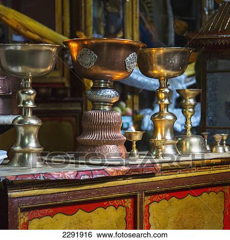 Ornate gold and bronze containers in a row on a table; Lhasa xizang china View Large Photo Image Stock Photograph - Ornate gold and bronze containers in a row on a table; Lhasa xizang china. Fotosearch
