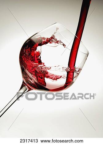 Red wine pouring into a glass View Large Photo Image Stock Image - Red wine pouring into a glass. Fotosearch
