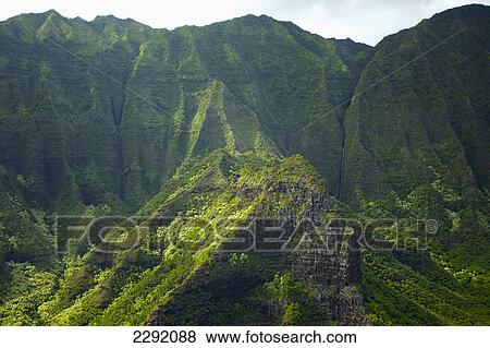 Rugged landscape of mountains covered in trees; Hawaii united states of america View Large Photo Image Stock Photo - Rugged landscape of mountains covered in trees; Hawaii united states of america. Fotosearch