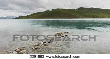 Shoreline of sacred lake under a cloudy sky; Shannan xizang china View Large Photo Image Stock Image - Shoreline of sacred lake under a cloudy sky; Shannan xizang china. Fotosearch