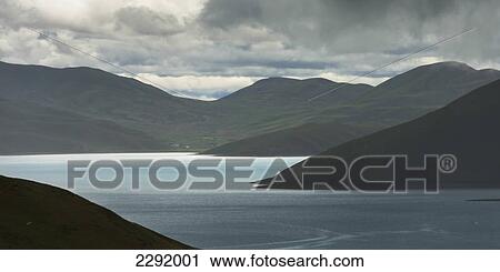 Stock Image - Shoreline of sacred lake under a cloudy sky; Shannan xizang china. Fotosearch