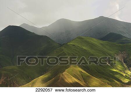 Sunlight and clouds cast patterns on the green mountains below; Lhasa xizang china View Large Photo Image Stock Photo - Sunlight and clouds cast patterns on the green mountains below; Lhasa xizang china. Fotosearch