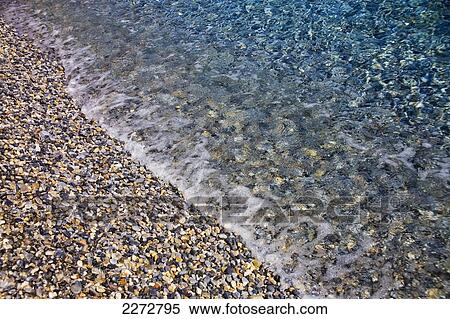 Stock Photography - Tide coming in on a rocky beach; England. Fotosearch