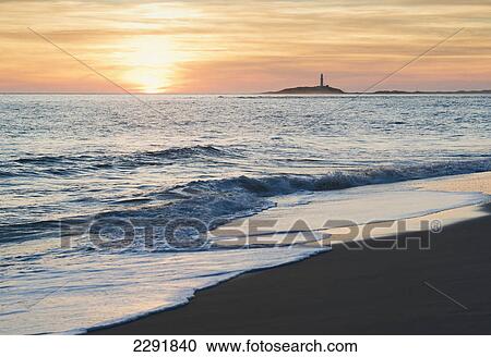 Stock Image - View of the coastline in the distance at sunset; Canos de meca costa de la luz cadiz andalusia spain. Fotosearch