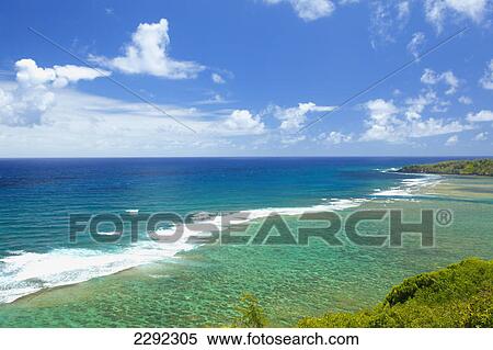 Stock Photography - Waves roll into the shore along the coastline of an hawaiian island; Hawaii united states of america. Fotosearch