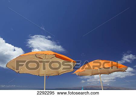 Yellow beach umbrellas against a blue sky with cloud and mountains on the coastline of an hawaiian island; Hawaii united states of america View Large Photo Image Stock Photography - Yellow beach umbrellas against a blue sky with cloud and mountains on the coastline of an hawaiian island; Hawaii united states of america. Fotosearch