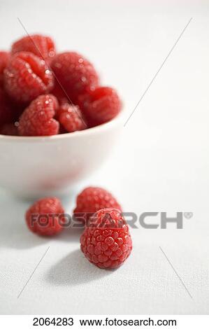 3 Raspberries Sit Beside Bowl Of Raspberries View Large Photo Image Stock Image - 3 Raspberries Sit Beside Bowl Of Raspberries. Fotosearch
