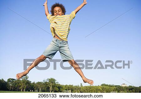 Stock Image - 8 Year Old Boy Jumps Very High, Winnipeg, Canada. Fotosearch