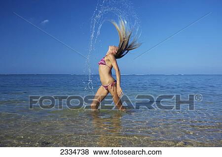 A blond haired woman flings her wet hair back; Kauai, Hawaii, United States of America View Large Photo Image Stock Photo - A blond haired woman flings her wet hair back; Kauai, Hawaii, United States of America. Fotosearch