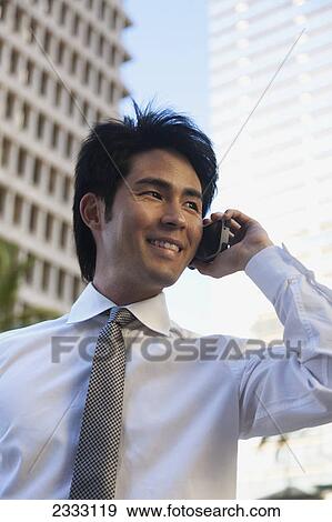 A businessman talking on a cell phone; Honolulu oahu hawaii united states of america View Large Photo Image Stock Photo - A businessman talking on a cell phone; Honolulu oahu hawaii united states of america. Fotosearch