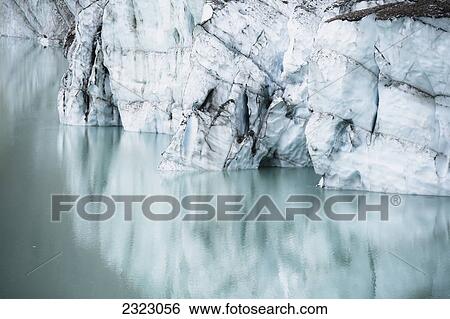 A cliff of ice reflected in a glacial lake jasper national park; Alberta canada View Large Photo Image Stock Photograph - A cliff of ice reflected in a glacial lake jasper national park; Alberta canada. Fotosearch