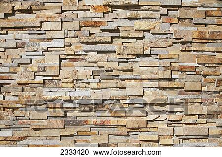 Stock Image - A contemporary stone wall; Honolulu hawaii united states of america. Fotosearch