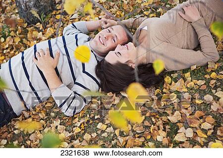 A Couple Laying In The Fallen Leaves In Autumn; St Albert Alberta Canada View Large Photo Image Stock Photo - A Couple Laying In The Fallen Leaves In Autumn; St Albert Alberta Canada. Fotosearch
