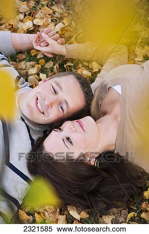 A Couple Laying In The Fallen Leaves In Autumn; St. Albert Alberta Canada View Large Photo Image Stock Photography - A Couple Laying In The Fallen Leaves In Autumn; St. Albert Alberta Canada. Fotosearch