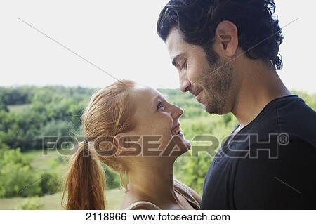 Stock Photograph - A Couple Looking Into Each Other's Eyes; Wailua Kauai Hawaii United States Of America. Fotosearch