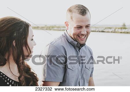 A couple walking on a beach and talking; White rock british columbia canada View Large Photo Image Stock Image - A couple walking on a beach and talking; White rock british columbia canada. Fotosearch