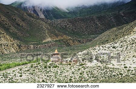 Stock Photo - A distant chorten on a mountain slope along the route from ghemi to lo manthang; Upper mustang nepal. Fotosearch