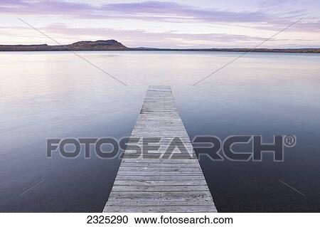 Stock Image - A dock in lake superior at sunset; Thunder bay ontario canada. Fotosearch