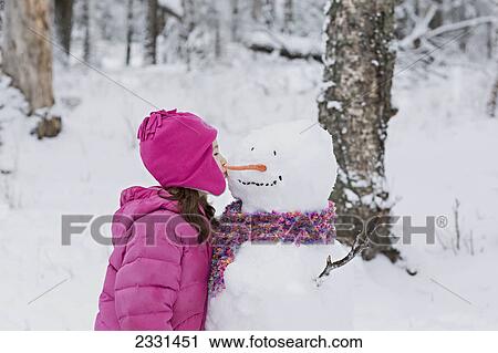 A girl kissing a snowman in winter; Palmer alaska united states of america View Large Photo Image Stock Image - A girl kissing a snowman in winter; Palmer alaska united states of america. Fotosearch