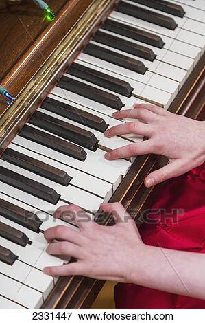 A girl's hands as she plays the piano; Anchorage alaska united states of america View Large Photo Image Stock Photo - A girl's hands as she plays the piano; Anchorage alaska united states of america. Fotosearch