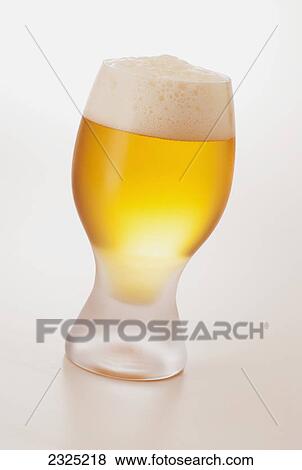 Stock Photo - A glass of cold beer with foam. Fotosearch